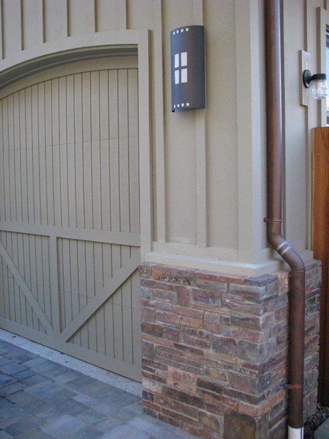 Garage with bat on board siding, brick, custom light 