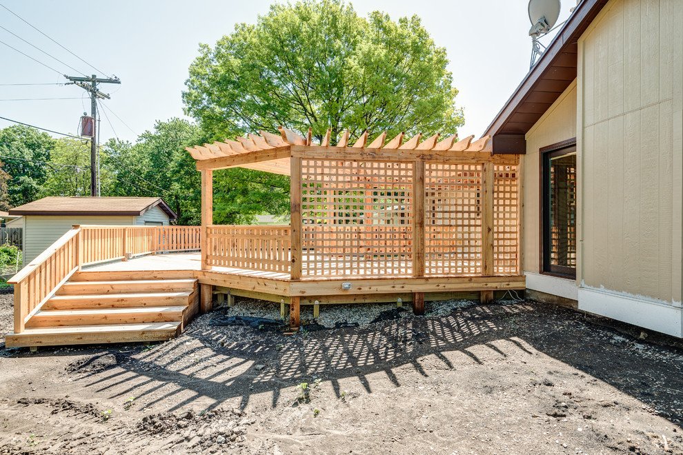 Large transitional backyard deck photo in Chicago with a pergola