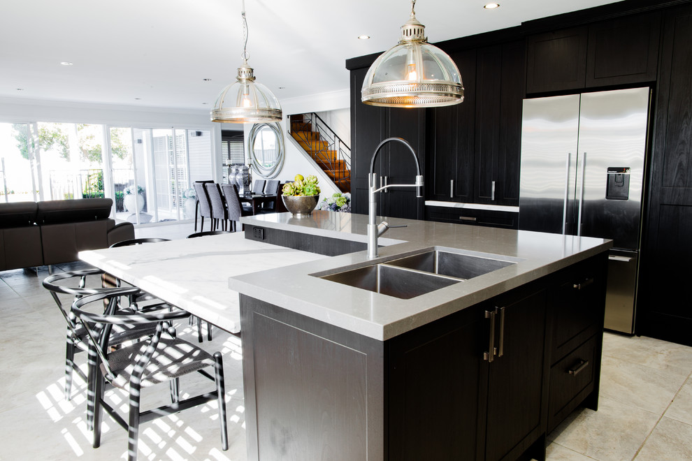 Photo of a small modern l-shaped open plan kitchen in Central Coast with a double-bowl sink, glass-front cabinets, black cabinets, quartz benchtops, white splashback, stone slab splashback, stainless steel appliances, ceramic floors, with island and grey floor.