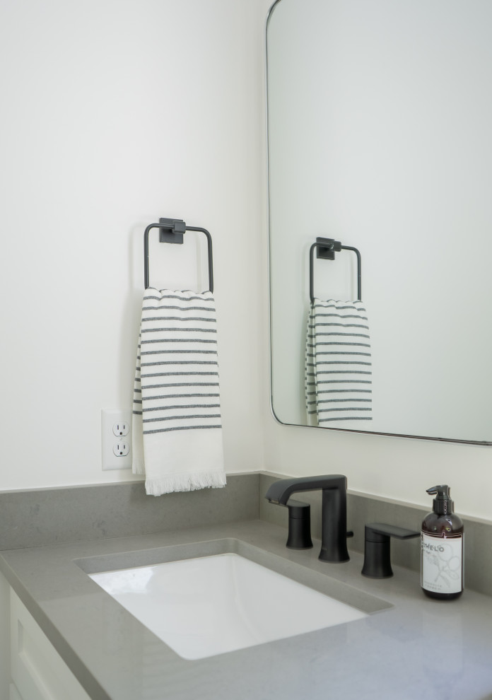 Example of a transitional gray tile and porcelain tile porcelain tile and double-sink bathroom design in Austin with shaker cabinets, white cabinets, white walls, quartz countertops, gray countertops and a built-in vanity