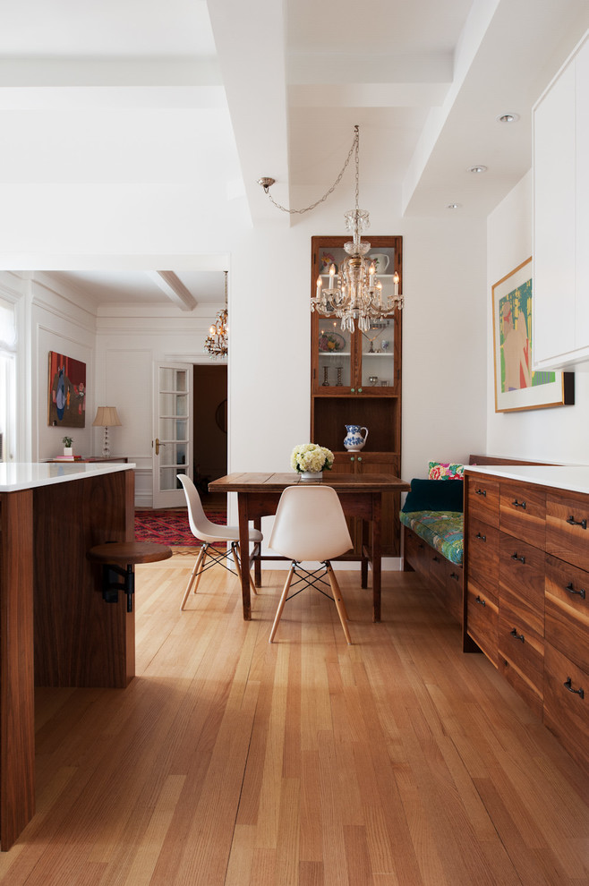 Photo of a mid-sized modern open plan dining in New York with white walls and light hardwood floors.