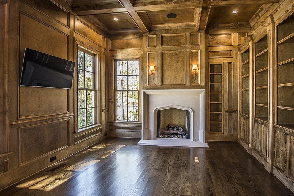 Inspiration for a large country study room in Atlanta with brown walls, dark hardwood floors, a standard fireplace and a concrete fireplace surround.