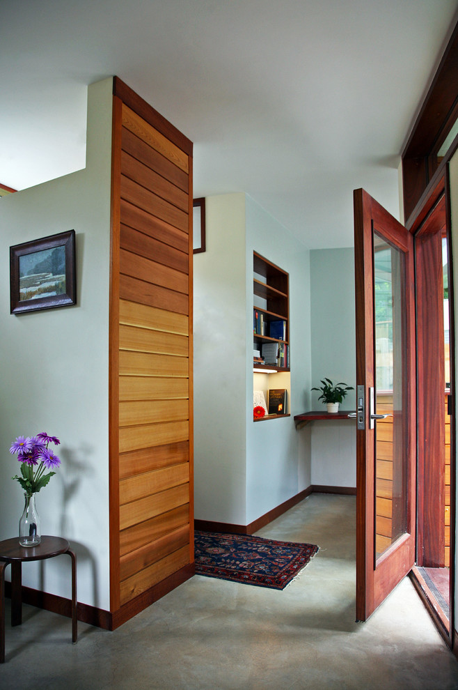 Transitional concrete floor entryway photo in Boston