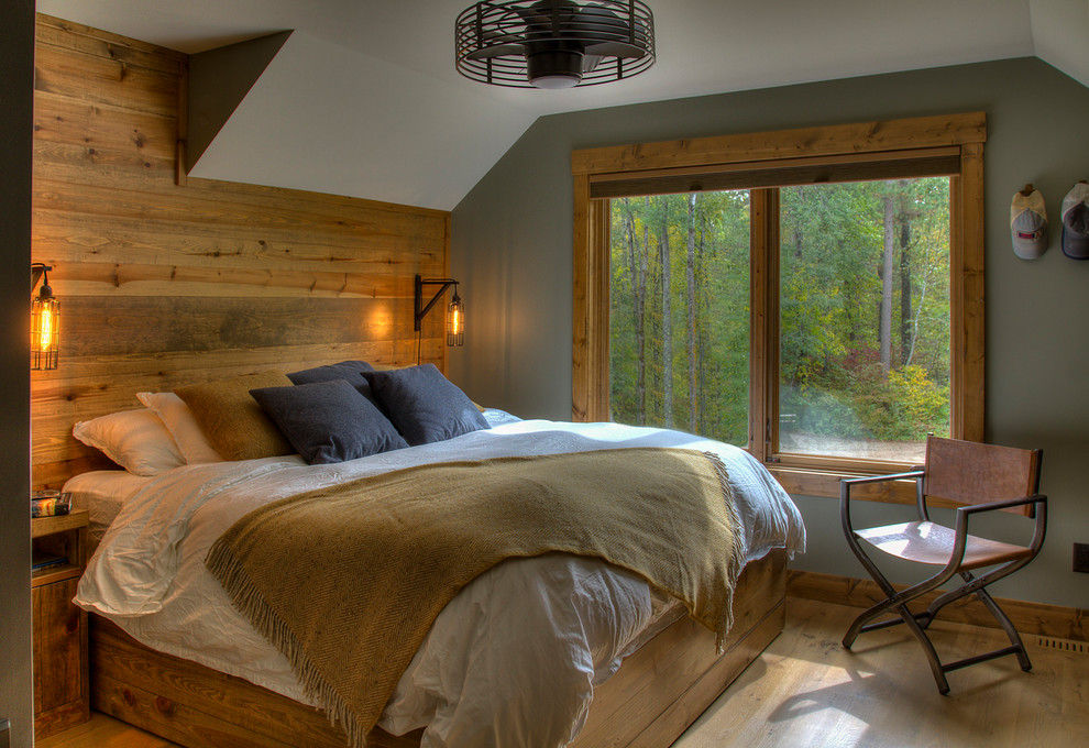 Example of a mountain style medium tone wood floor and brown floor bedroom design in Minneapolis with gray walls