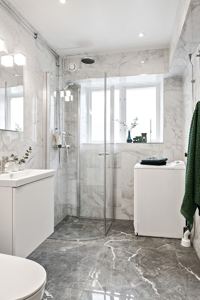 Mid-sized transitional 3/4 bathroom in Other with flat-panel cabinets, white cabinets, a corner shower, gray tile, white tile, marble, marble floors, a drop-in sink, a hinged shower door, grey walls and grey floor.