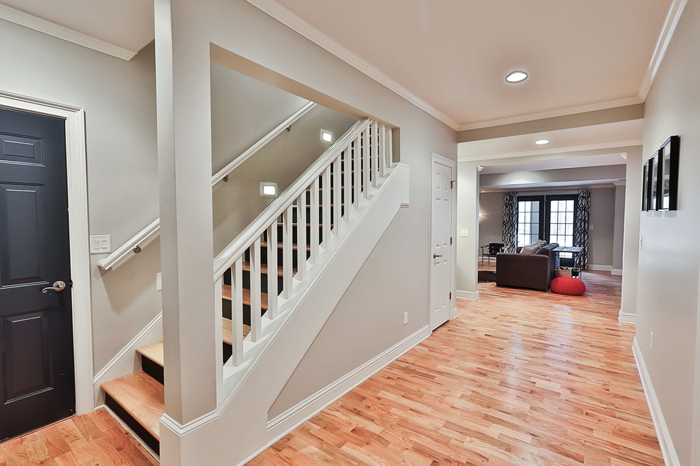 Inspiration for a mid-sized transitional walk-out basement in Atlanta with grey walls, light hardwood floors, no fireplace and beige floor.