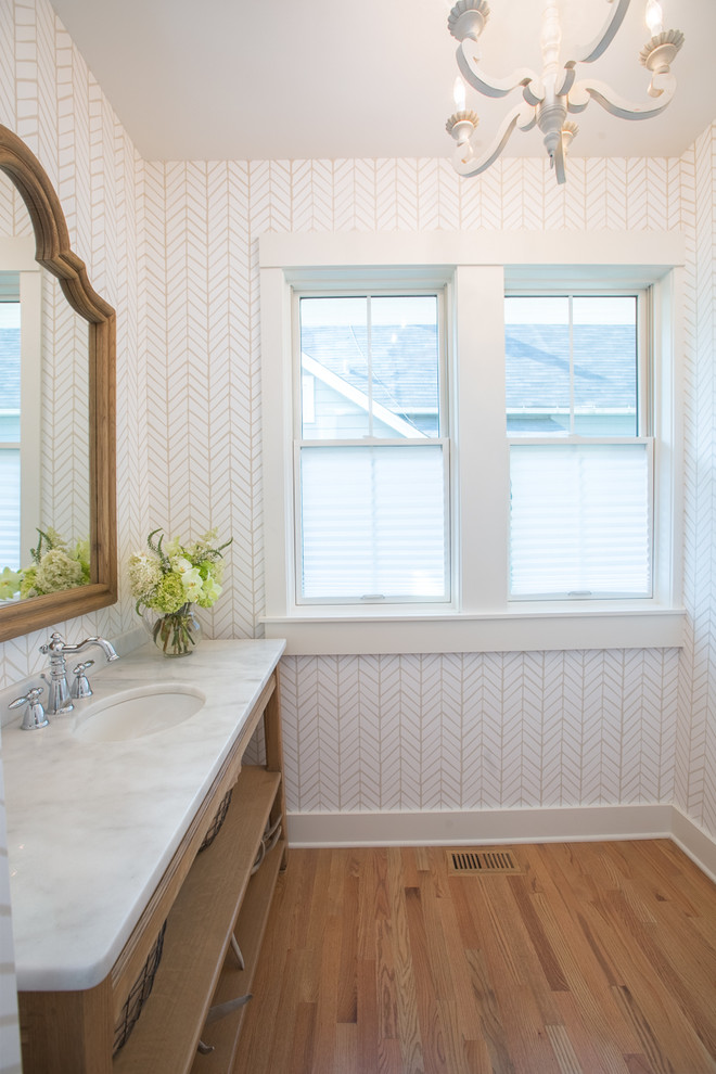 Example of a transitional medium tone wood floor bathroom design in Chicago with open cabinets, medium tone wood cabinets, white walls, an undermount sink and marble countertops
