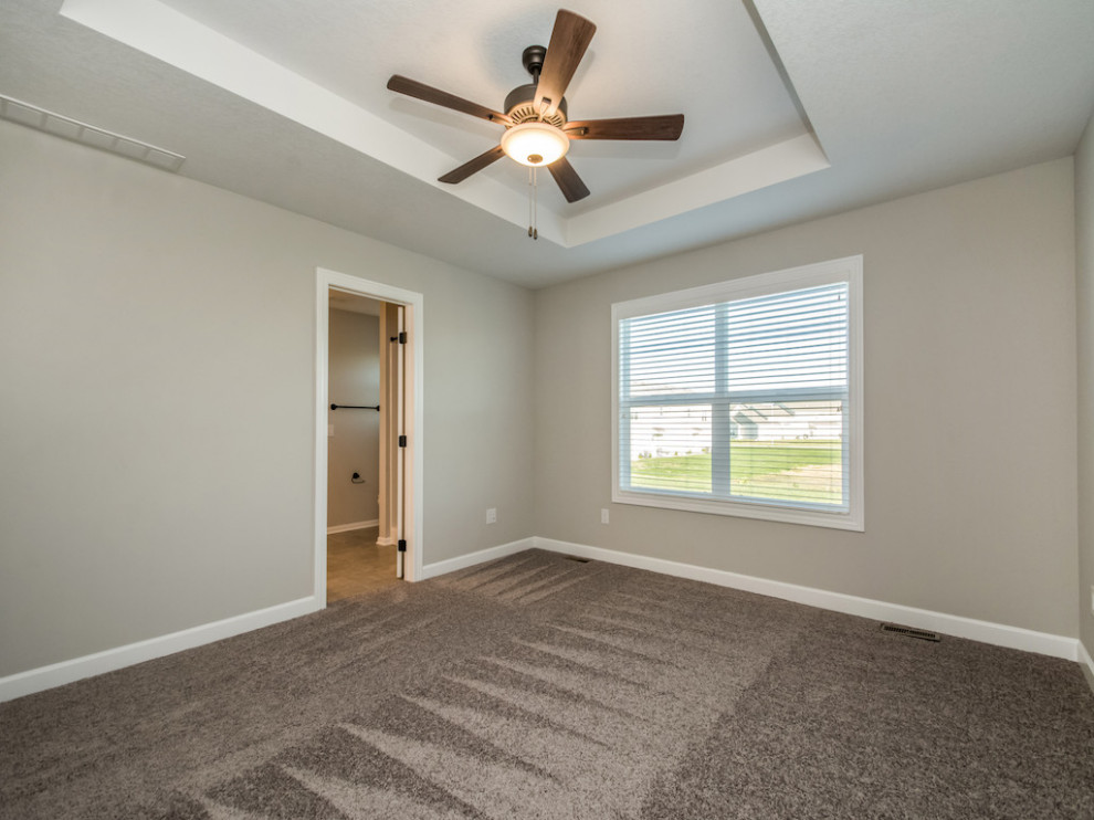 Bedroom - large transitional master carpeted and gray floor bedroom idea with beige walls