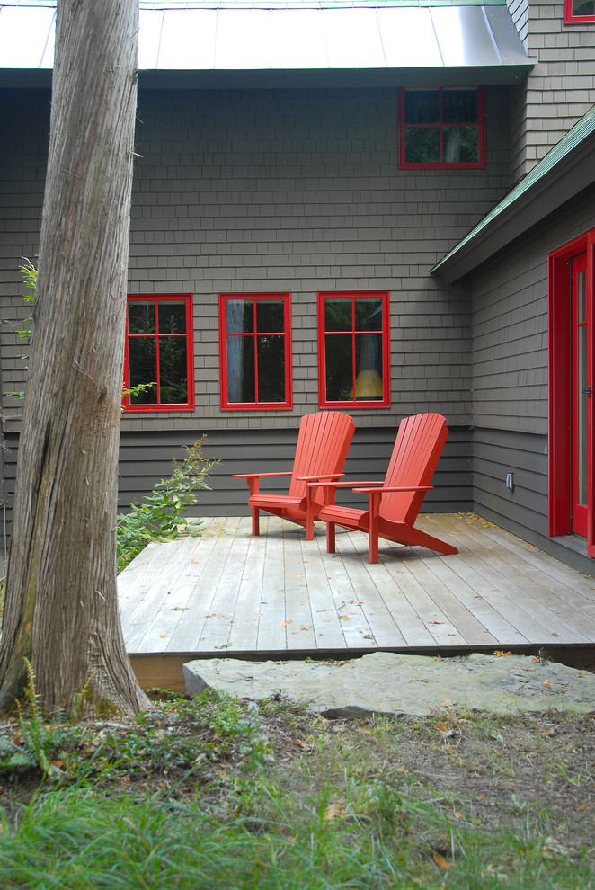 Photo of a small country backyard deck in Burlington with no cover.