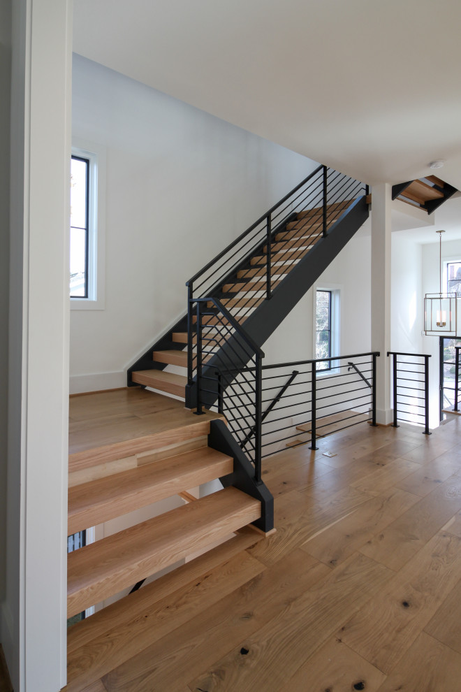 Design ideas for a medium sized contemporary wood straight metal railing staircase in DC Metro.
