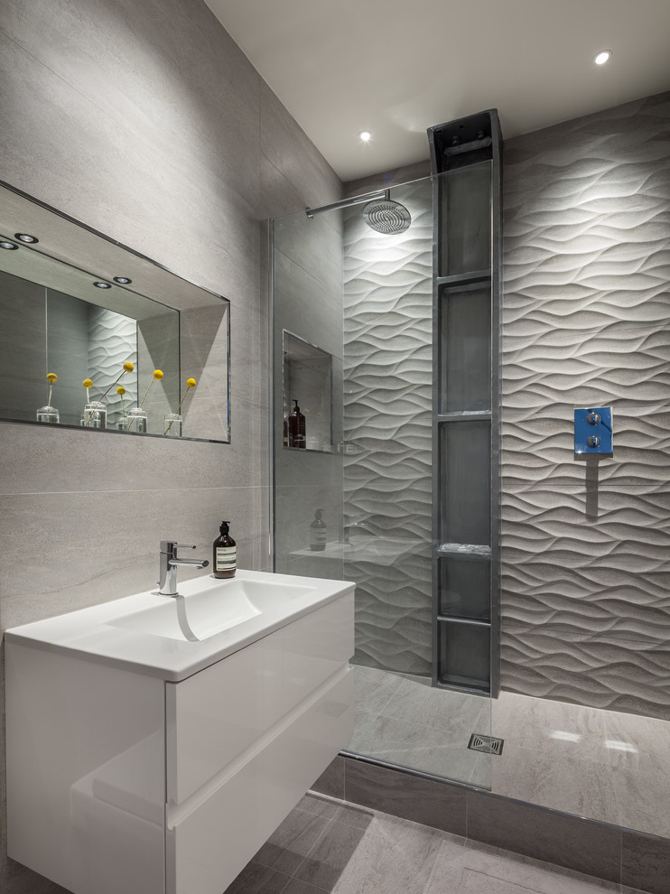 Photo of a mid-sized contemporary master bathroom in London with gray tile, porcelain tile, an open shower, an integrated sink, flat-panel cabinets, white cabinets and an open shower.