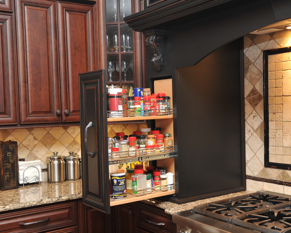 Eat-in kitchen - large transitional u-shaped dark wood floor eat-in kitchen idea with an island, raised-panel cabinets, dark wood cabinets, beige backsplash, stainless steel appliances, an undermount sink, granite countertops and ceramic backsplash