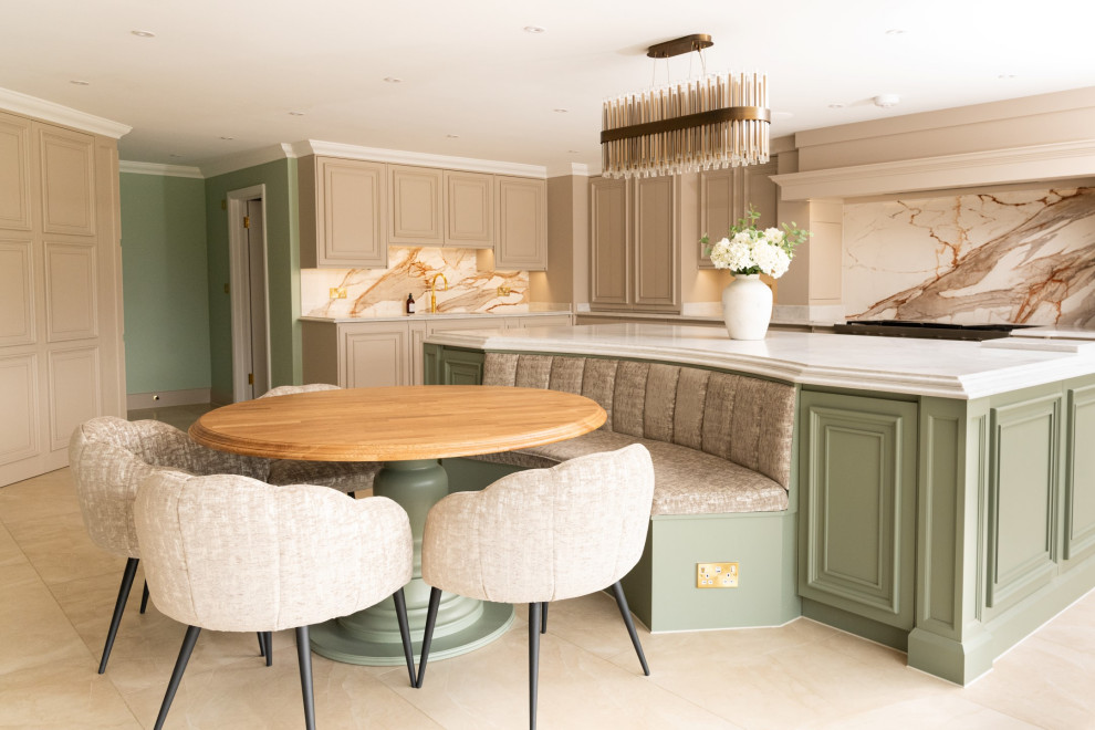 This is an example of an expansive contemporary l-shaped open plan kitchen in Essex with a double-bowl sink, shaker cabinets, grey cabinets, quartzite benchtops, orange splashback, porcelain splashback, stainless steel appliances, travertine floors, with island, brown floor and white benchtop.