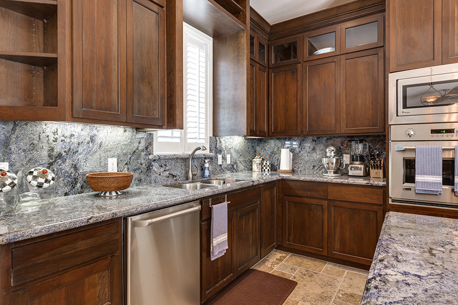 Mid-sized transitional travertine floor eat-in kitchen photo in Austin with an undermount sink, granite countertops, stainless steel appliances and an island