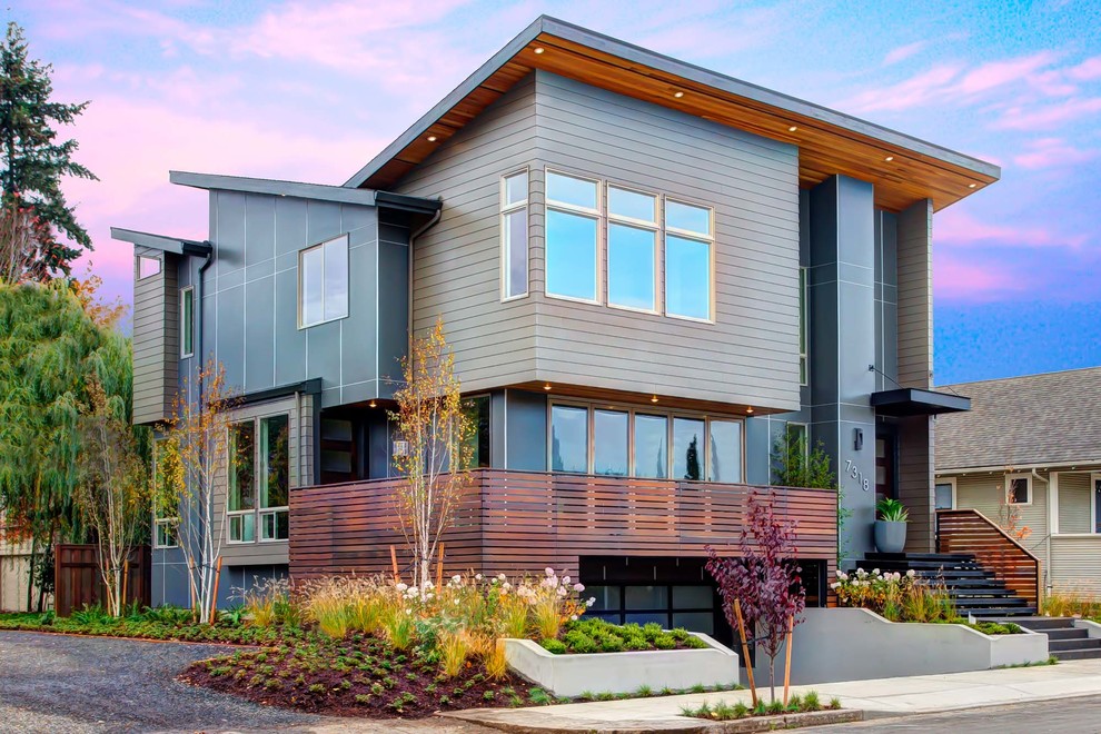 Photo of a large contemporary three-storey grey exterior in Portland with mixed siding and a shed roof.
