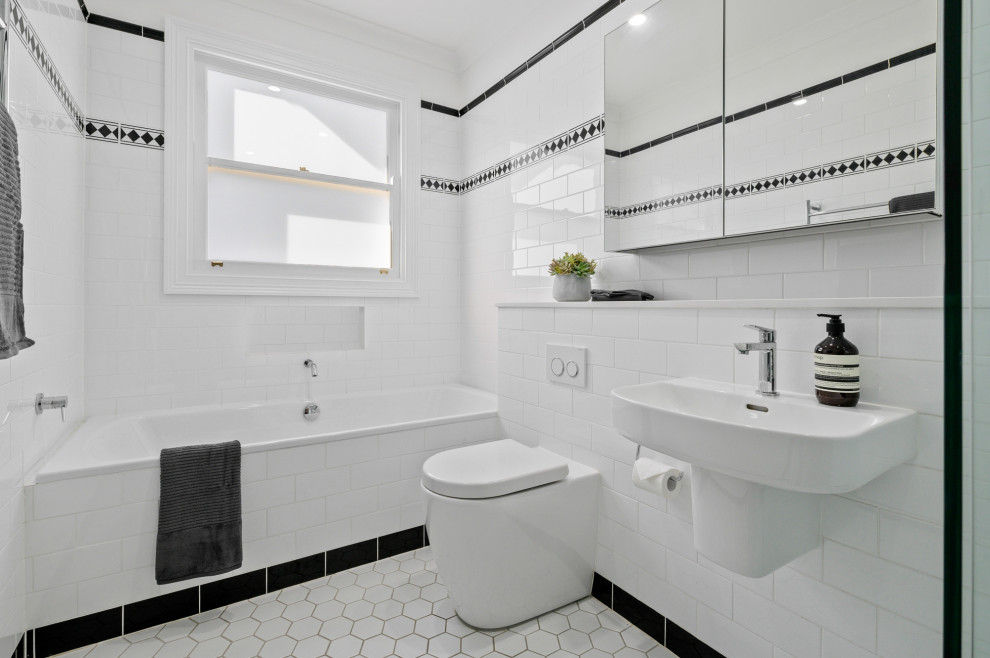Inspiration for a mid-sized transitional master bathroom in Sydney with a corner shower, black and white tile, ceramic tile, porcelain floors, a wall-mount sink, white floor, a single vanity, an alcove tub, a one-piece toilet and an open shower.