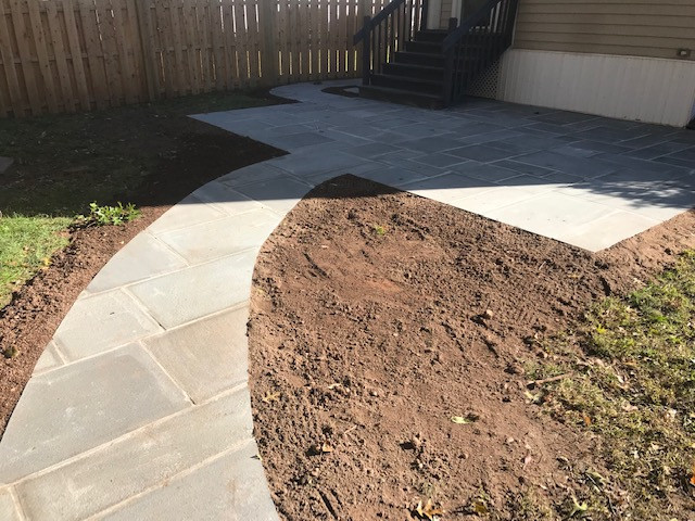 Bluestone patio wet lay with walkway and landscape