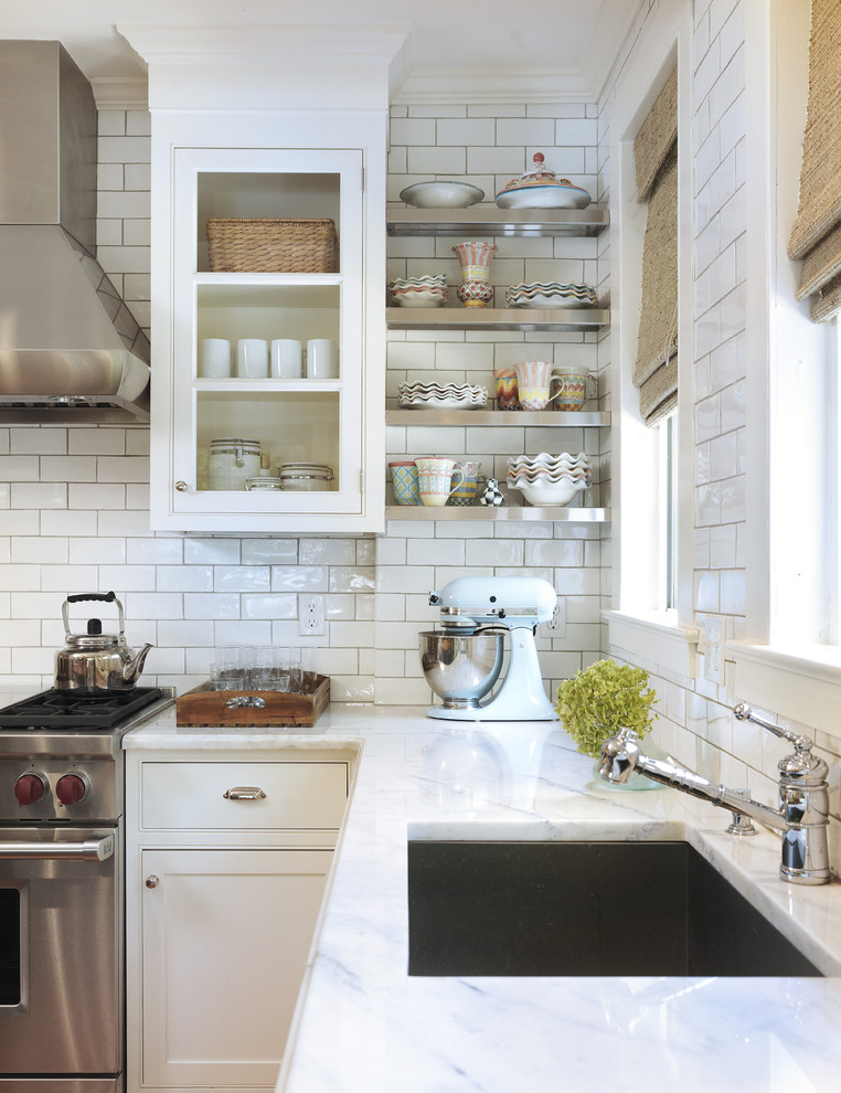 Photo of a traditional kitchen in Providence with beaded inset cabinets, stainless steel appliances, a single-bowl sink, white cabinets, marble benchtops, white splashback and subway tile splashback.