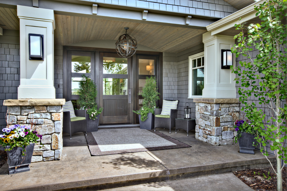 Inspiration for a traditional front yard verandah in Calgary with concrete slab.