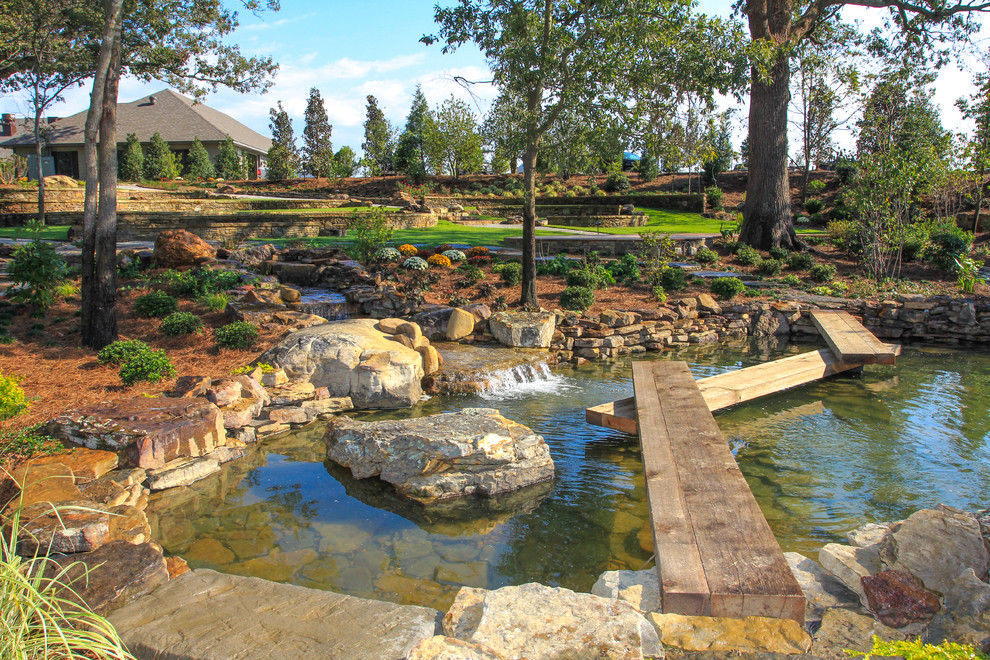 Inspiration for an eclectic garden in Little Rock with a water feature.