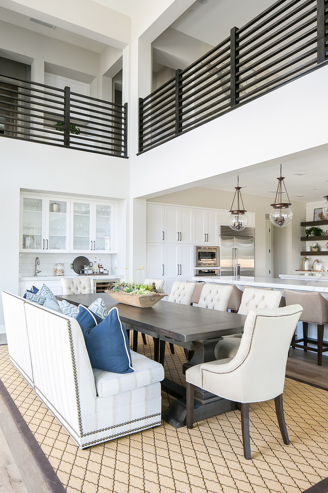 Photo of a beach style open plan dining in San Diego with grey walls and medium hardwood floors.