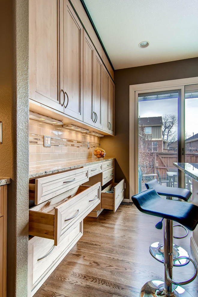 Example of a mid-sized transitional u-shaped dark wood floor kitchen pantry design in Denver with an undermount sink, flat-panel cabinets, light wood cabinets, granite countertops, beige backsplash, glass tile backsplash, stainless steel appliances and an island