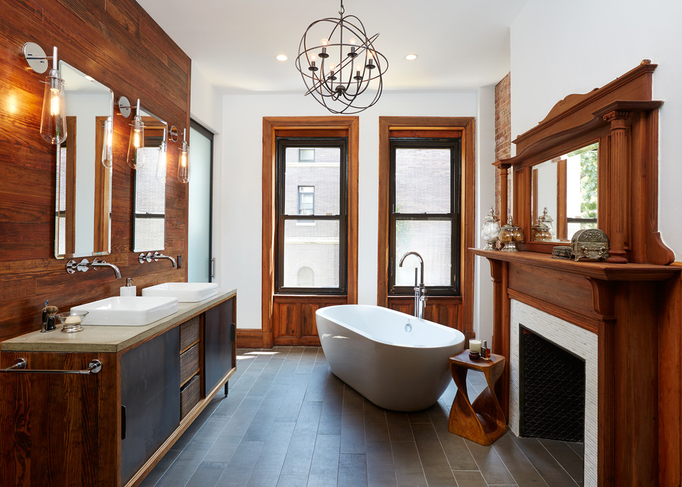 Large transitional master bathroom in New York with a freestanding tub, an open shower, white walls, ceramic floors, a vessel sink, concrete benchtops, flat-panel cabinets and black cabinets.