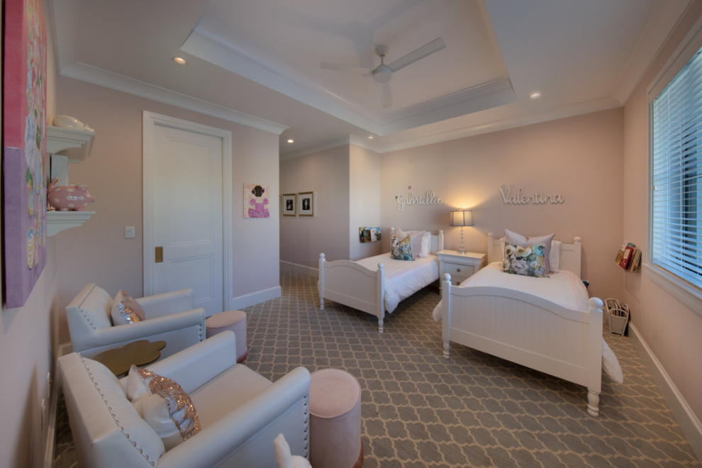 This is an example of a traditional children’s room for girls in Miami with pink walls, carpet and a coffered ceiling.