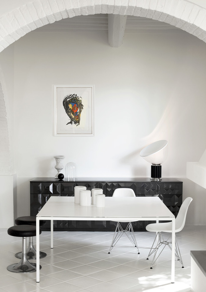 Mid-sized contemporary dining room in Florence with white walls and porcelain floors.