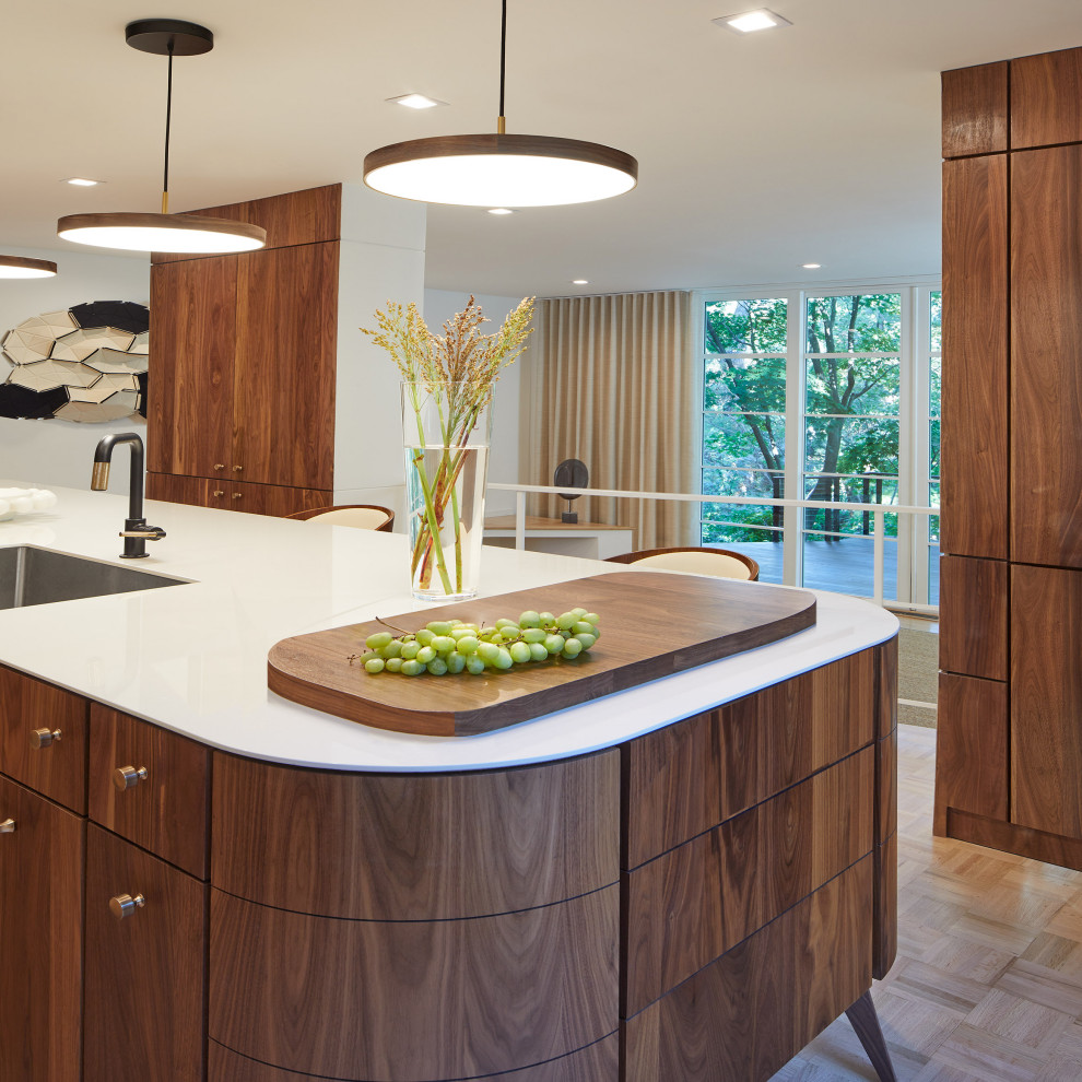 Example of a small mid-century modern galley light wood floor and beige floor open concept kitchen design in DC Metro with an undermount sink, flat-panel cabinets, dark wood cabinets, white backsplash, quartz backsplash, paneled appliances, an island, white countertops and quartz countertops
