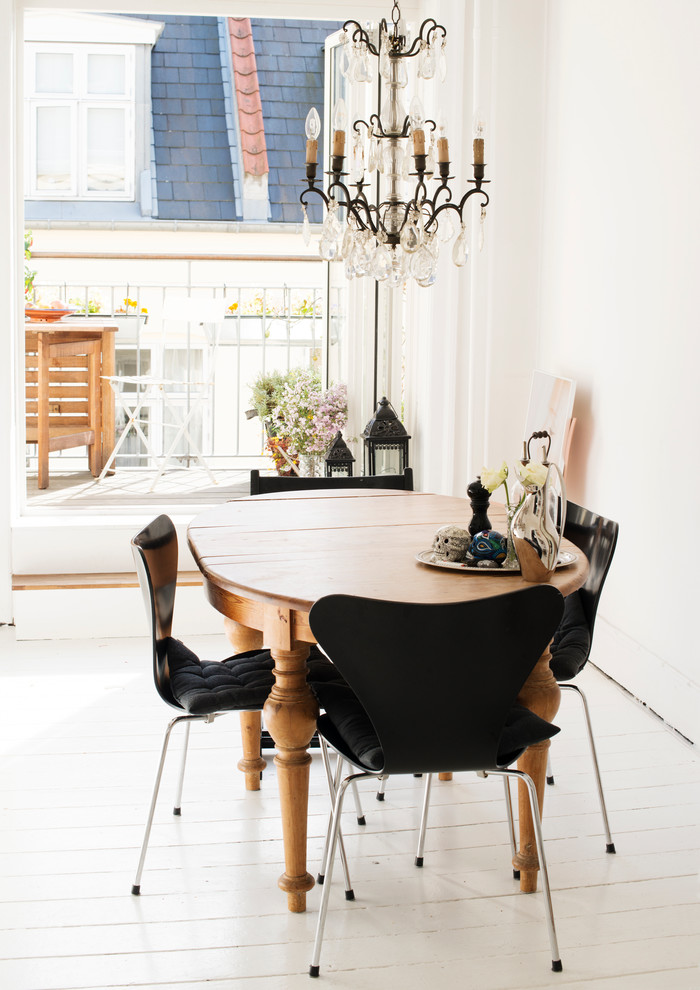 Design ideas for a mid-sized transitional separate dining room in Copenhagen with white walls, painted wood floors and no fireplace.