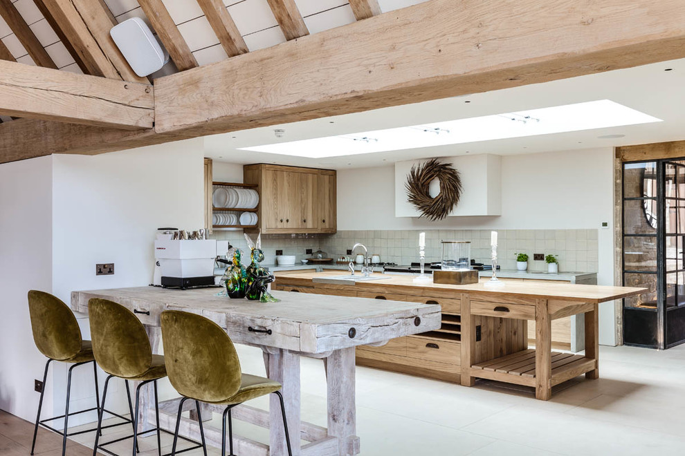Design ideas for a country kitchen in Gloucestershire with limestone floors and beige floor.
