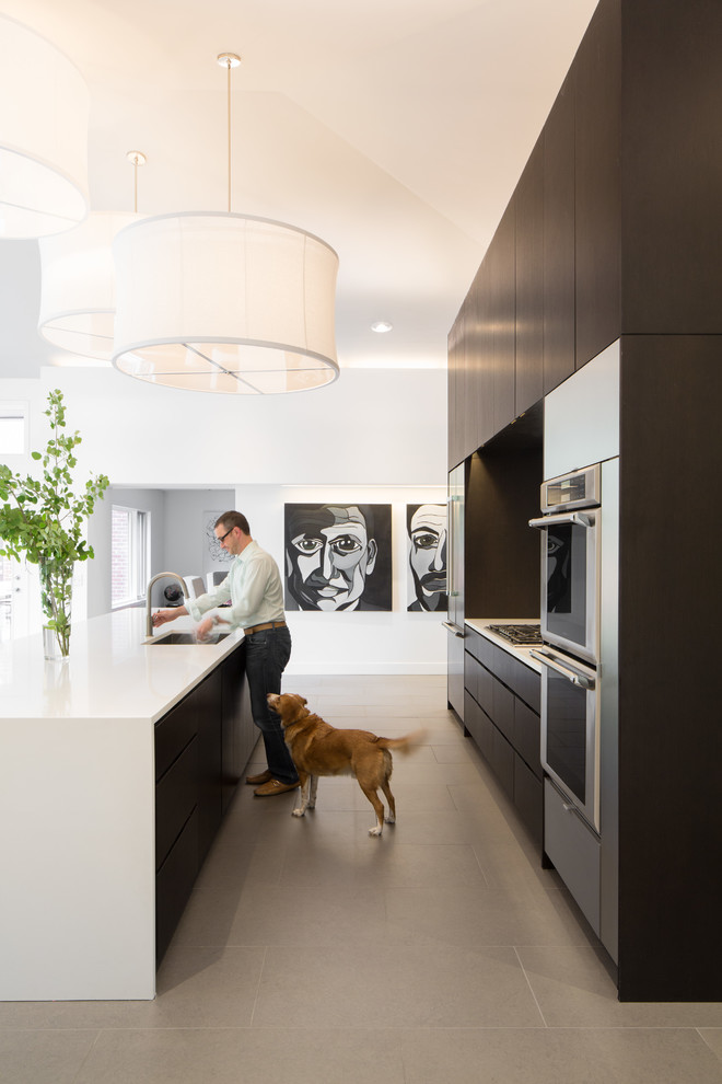 Inspiration for a contemporary eat-in kitchen in Denver with dark wood cabinets, quartzite benchtops, stone slab splashback, stainless steel appliances, porcelain floors and with island.