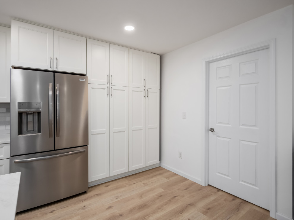 Example of a small transitional galley eat-in kitchen design in Columbus with shaker cabinets, white cabinets, quartz countertops and white countertops