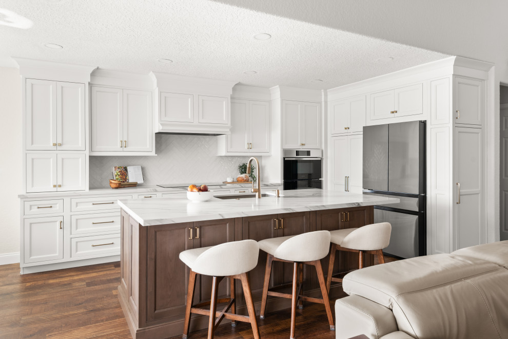 Inspiration for a transitional kitchen remodel in Orlando with white cabinets, quartzite countertops, gray backsplash, ceramic backsplash, an island and white countertops