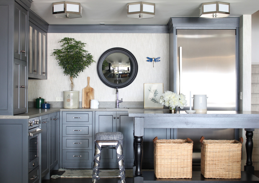 Transitional l-shaped dark wood floor and brown floor kitchen photo in Omaha with an undermount sink, recessed-panel cabinets, gray cabinets, stainless steel appliances, an island and gray countertops