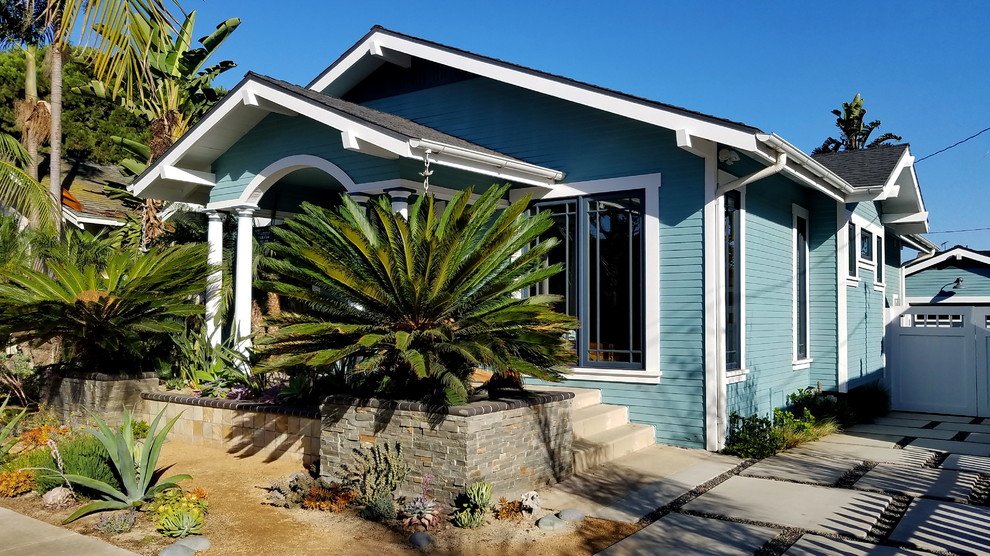 Arts and crafts one-storey blue house exterior in Los Angeles with wood siding, a gable roof and a shingle roof.