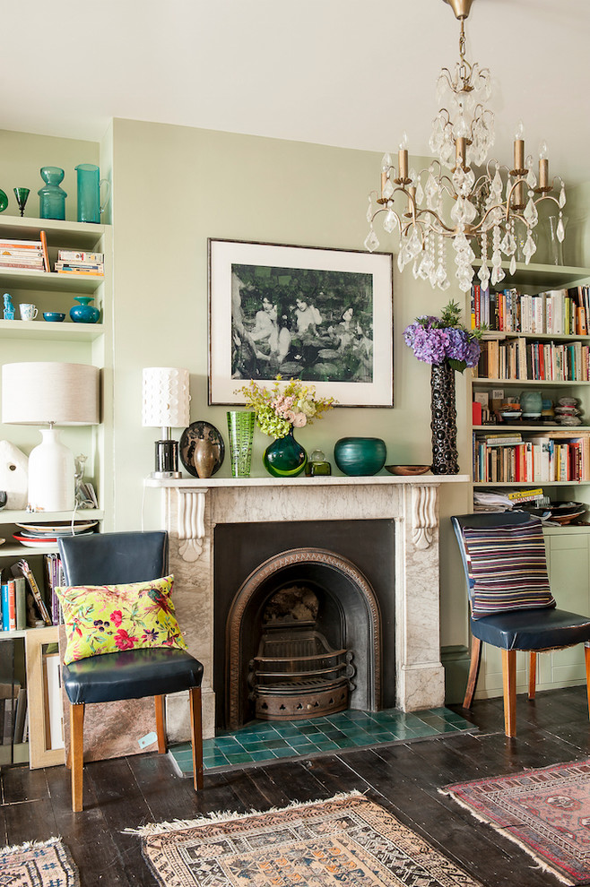 Design ideas for a mid-sized eclectic formal enclosed living room in Sussex with green walls, painted wood floors, a stone fireplace surround and a standard fireplace.