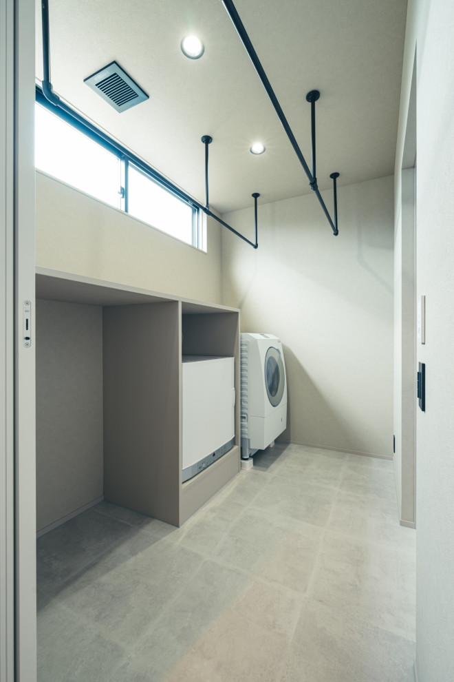 Design ideas for a modern single-wall utility room in Other with open cabinets, white cabinets, wood benchtops, white walls, ceramic floors, a side-by-side washer and dryer, grey floor, white benchtop, wallpaper and wallpaper.