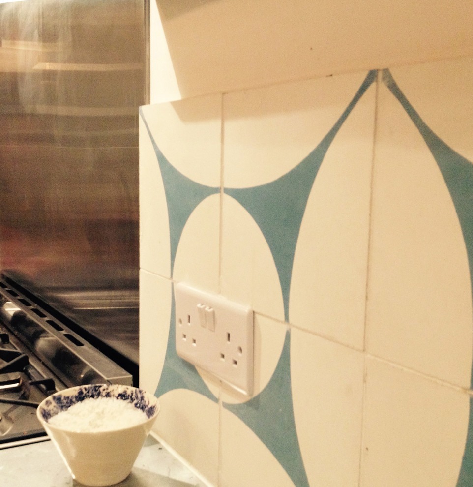 Design ideas for a contemporary kitchen in London with blue splashback and cement tile splashback.