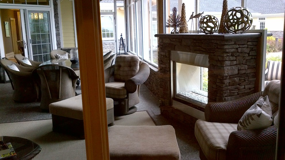 Home design - large transitional backyard stone screened-in home design idea in Toronto with a roof extension