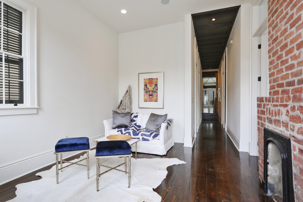 Design ideas for a mid-sized transitional foyer in New Orleans with white walls, dark hardwood floors, a double front door, an orange front door and brown floor.