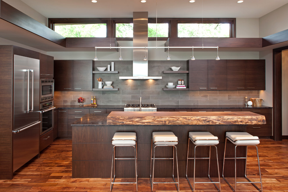 Inspiration for a contemporary l-shaped kitchen in Minneapolis with flat-panel cabinets, dark wood cabinets, wood benchtops and stainless steel appliances.