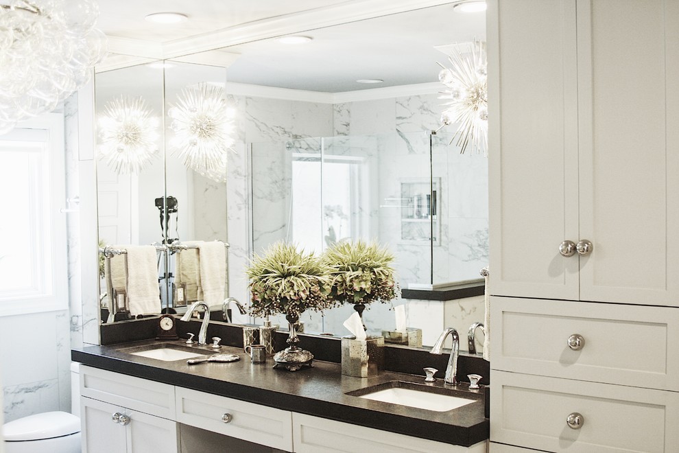 Inspiration for a large transitional master gray tile, white tile and porcelain tile alcove shower remodel with shaker cabinets, white cabinets, a two-piece toilet, white walls, an undermount sink, solid surface countertops and a hinged shower door