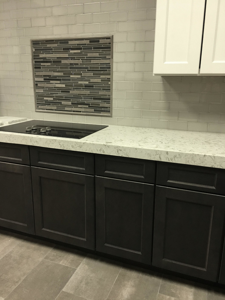 Mid-sized transitional l-shaped porcelain tile enclosed kitchen photo in Austin with raised-panel cabinets, dark wood cabinets, granite countertops, beige backsplash, stainless steel appliances, no island and porcelain backsplash