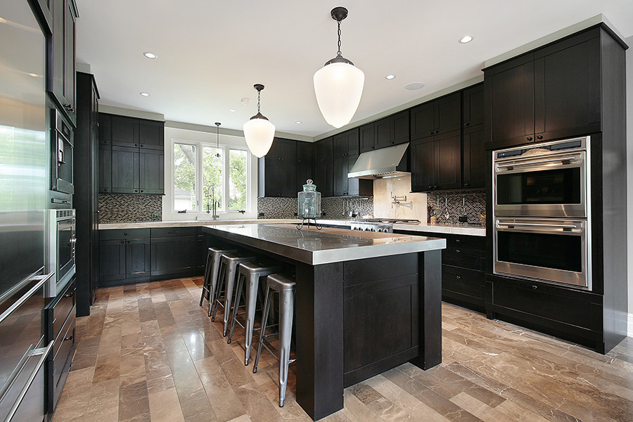 This is an example of a large modern u-shaped eat-in kitchen in New York with an undermount sink, shaker cabinets, black cabinets, stainless steel benchtops, multi-coloured splashback, mosaic tile splashback, stainless steel appliances, marble floors, with island and brown floor.