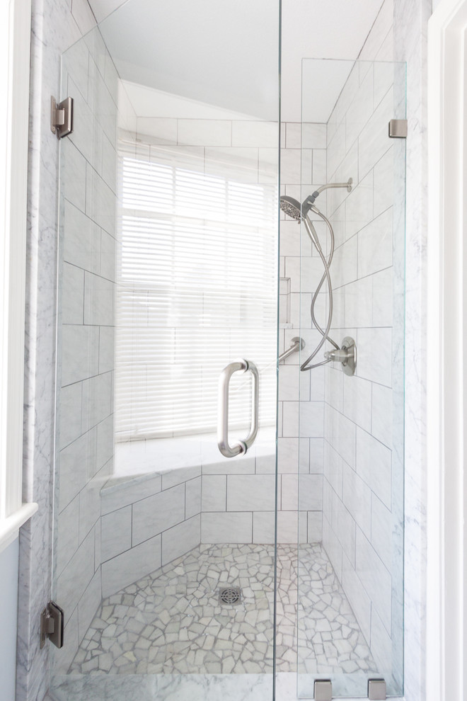 Freestanding bathtub - transitional master white tile and subway tile porcelain tile and white floor freestanding bathtub idea with raised-panel cabinets, gray cabinets, white walls, an undermount sink, marble countertops and a hinged shower door