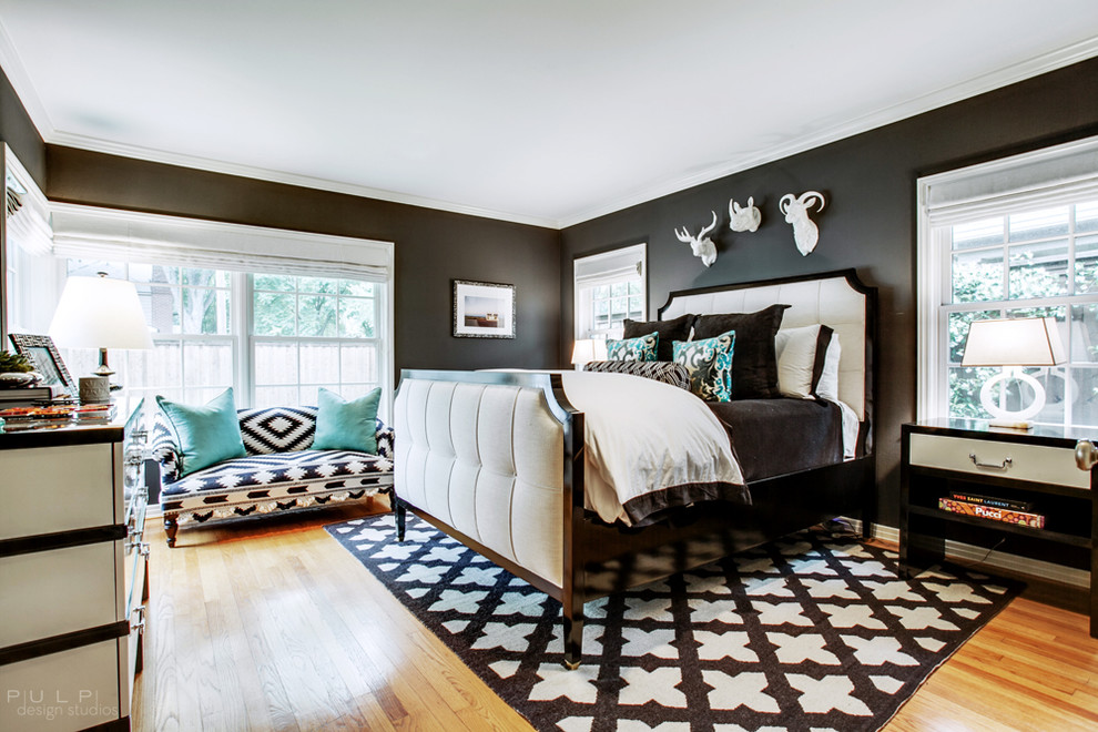 This is an example of a large contemporary master bedroom in Seattle with black walls, light hardwood floors, no fireplace and brown floor.