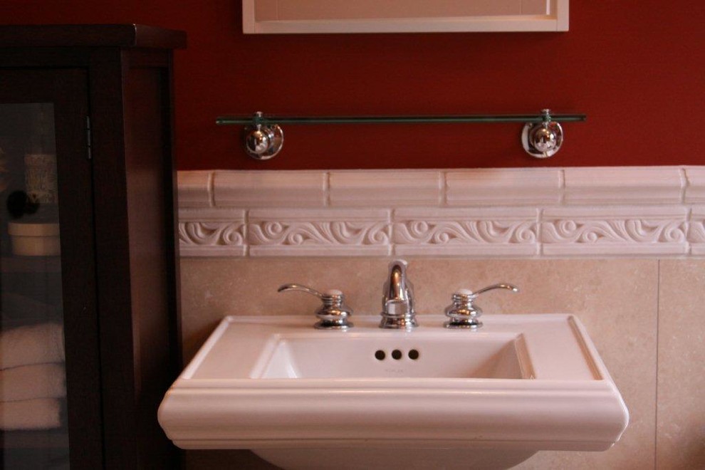 This is an example of a traditional master bathroom in Detroit with glass-front cabinets, dark wood cabinets, white tile, ceramic tile, red walls and a pedestal sink.