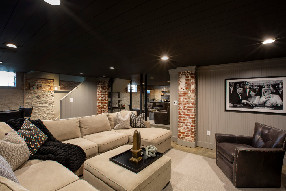 This is an example of a medium sized urban fully buried basement in Columbus with grey walls, concrete flooring and a timber clad ceiling.